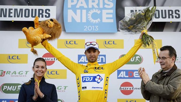 Nacer Bouhanni celebrates on the podium after receiving the yellow jersey following the first stage of the 71st Paris-Nice race.