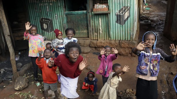 Children cheer and wave during Pope Francis' visit to the Kangemi slum, in Nairobi, Kenya.