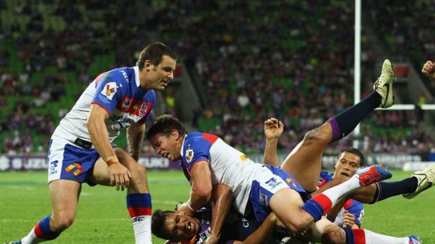 Where there's a Will ... Storm centre Will Chambers touches down despite the best efforts of James McManus and Kurt Gidley during Melbourne's 12-point victory at AAMI Stadium last night.