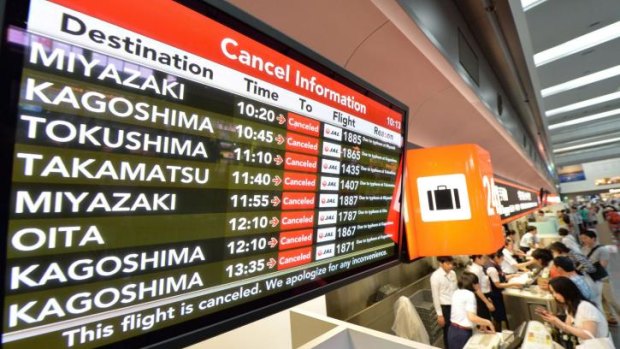A flight information board displays cancellation information due to Typhoon Halong at Tokyo's Haneda airport.