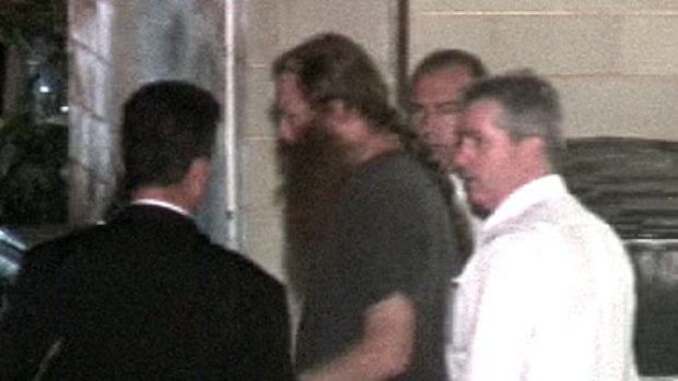 Vernon Silich is led away by police at the time of his arrest.