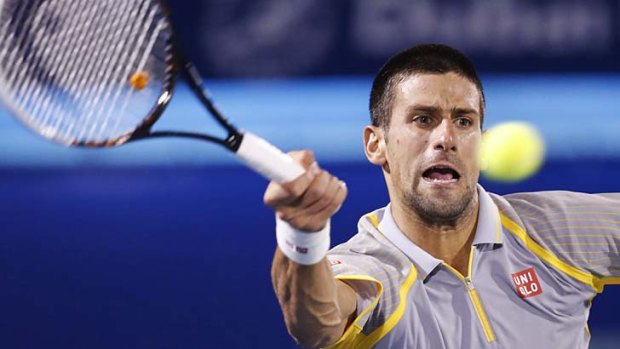 Novak Djokovic hits a return to Roberto Bautista Agut of Spain.