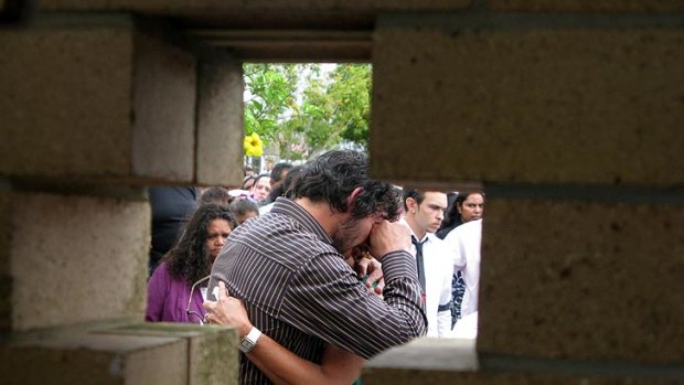 Johnathan Thurston is comforted at the funeral of his uncle Richard Saunders.