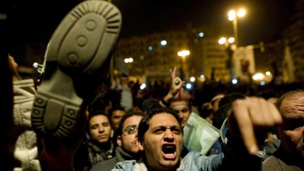 A protester waves his shoe in disgust after President Hosni Mubarak revealed he wasn't going to resign.