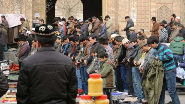 Backlash: Ulghur worshippers at Friday prayer at the central mosque in Hotan.