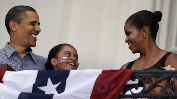 Barack Obama, Michelle and daughters Malia (centre) and Sasha during Fourth of July celebrations at the White House. 