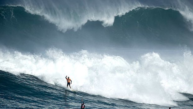 Kelly Slater pumps his fist after surviving the white water of this wave in the second heat, scoring 98 out of a possible 100 points