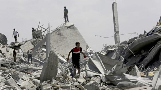 Palestinians search the rubble of homes destroyed by Israeli bombardment in Khuza'a in Gaza.