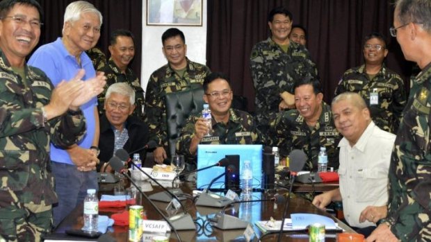 Philippine Military Chief General Gregorio Catapang, centre, reacts after learning about the safe repositioning of Filipino peacekeepers in Golan Heights.