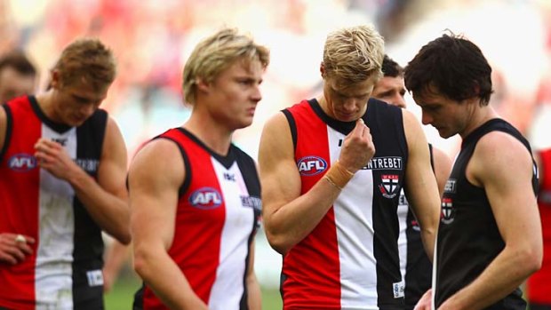 Sinking feeling: Clint Jones, captain Nick Riewoldt and Farren Ray after yesterday's loss to Sydney at ANZ Stadium.