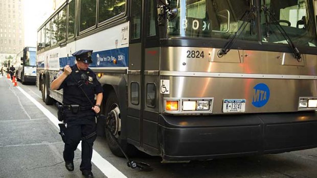 A New York police officer inspects a bus on Trinity Place near the World Trade Centre.