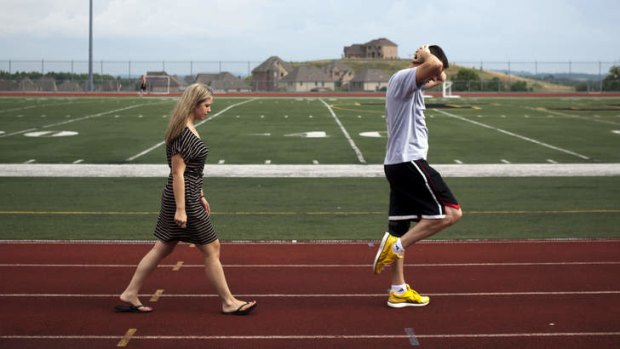 Marine Sergeant Ron Strang with his girlfriend at a running track.