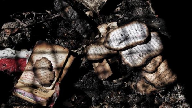 Burned pages of religious scripture among debris in a shrine in Tunisia.