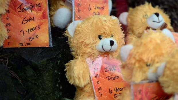 Teddy bears show the names of some of the victims of an elementary school shooting, including Jack Pinto.