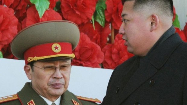 North Korean leader Kim Jong-un, right, walks past his uncle North Korean politician Jang Song-thaek, during a military parade.