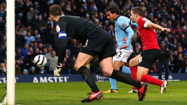 Carlos Tevez scores the opening goal against Barnsley.
