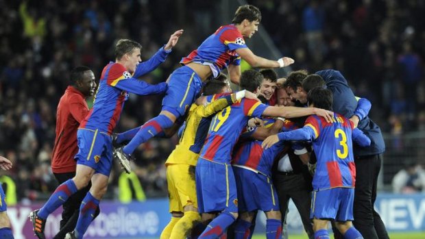 Joy ... Basel players celebrate after beating Manchester United.
