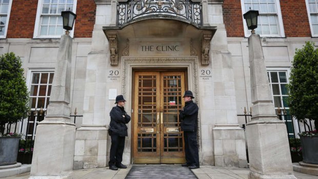 Keeping watch: Police stand on guard outside The London Clinic on Friday, where Prince Philip was admitted.