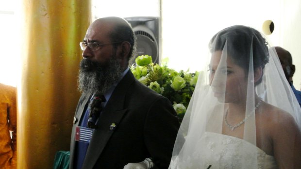 West Papuan independence leader Filep Karma, who was allowed out of prison for a day to give his daughter away at her wedding in Jayapura, defiantly wears the outlawed "Morning Star" flag on his chest. Raising the flag in 2004 saw him sentenced to 15 years' jail.