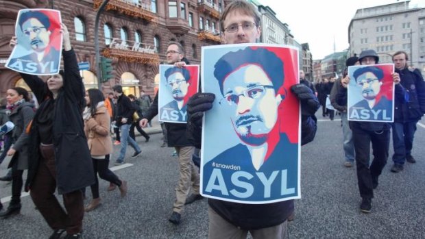 Protesters demand that Germany grant  Edward Snowden asylum  during a march  in Hamburg.