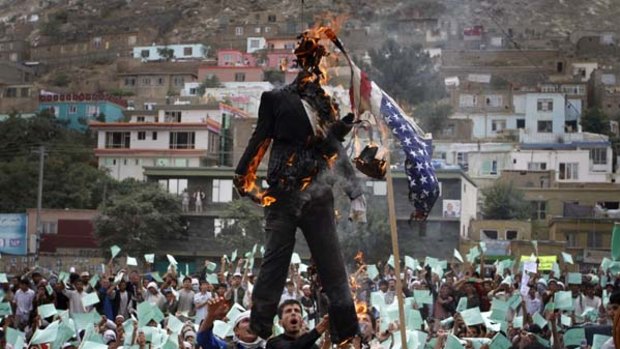 Fired up ... Afghans burn an effigy of Pastor Terry Jones during a demonstration against the US in Kabul.