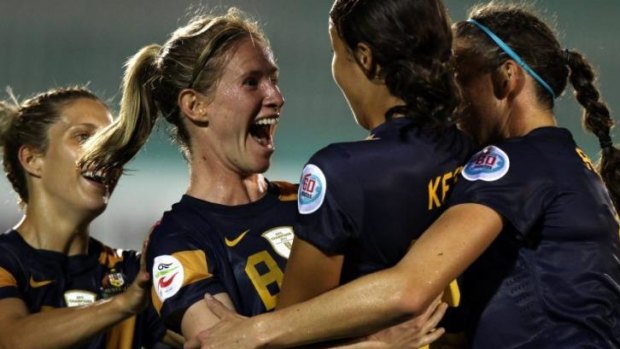 Elise Kellond-Knight (second left) of Australia celebrates with her team-mates after she scored the winning goal.