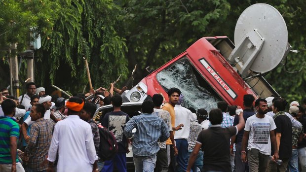 Dera Sacha Sauda sect members overturned a OB van on the streets of Panchkula, India on Friday.