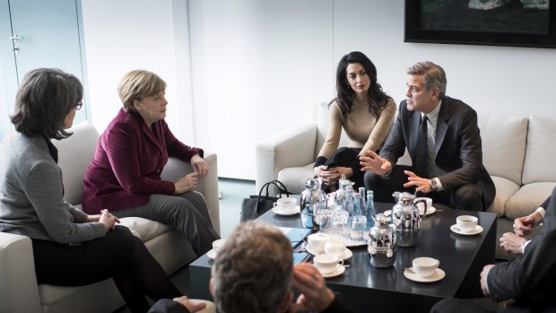 German Chancellor  Angela Merkel (second from left) meets with George and Amal Clooney.