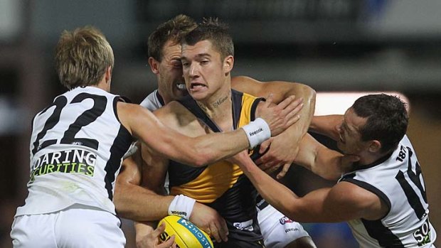 Under pressure: Richmond's Dustin Martin is surrounded by a bunch of Port Adelaide players.
