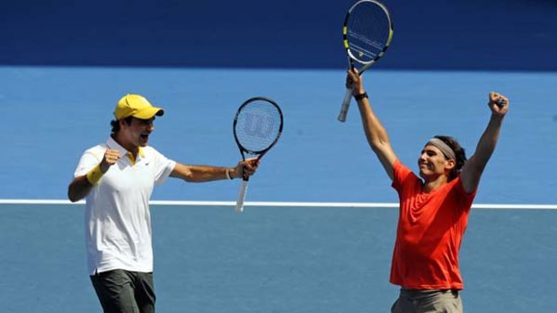 Roger Federer and rival Rafael Nadal play doubles in yesterday's flood relief match.