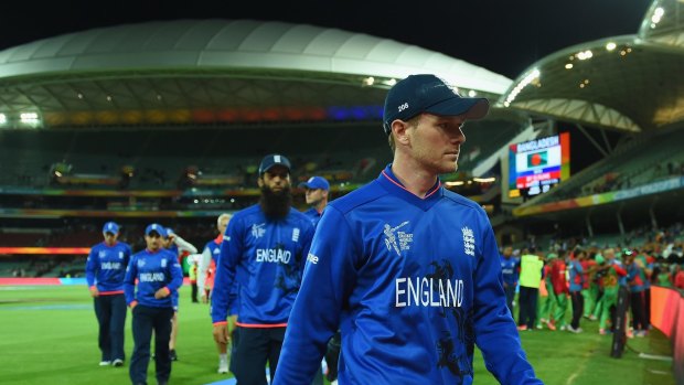 Humiliated: England captain Eoin Morgan leads a line of dejected players off the field.
