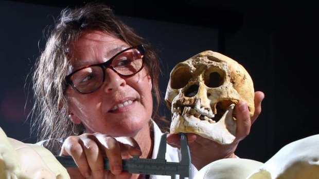 See any resemblance? Susan Hayes holds a replica of the Homo floresiensis skull or the "hobbit"