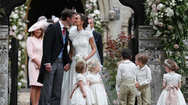 Pippa Middleton and James Matthews kiss after their wedding.