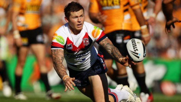 Working towards a win... Todd Carney gets a pass away for the Roosters against the Tigers yesterday.
