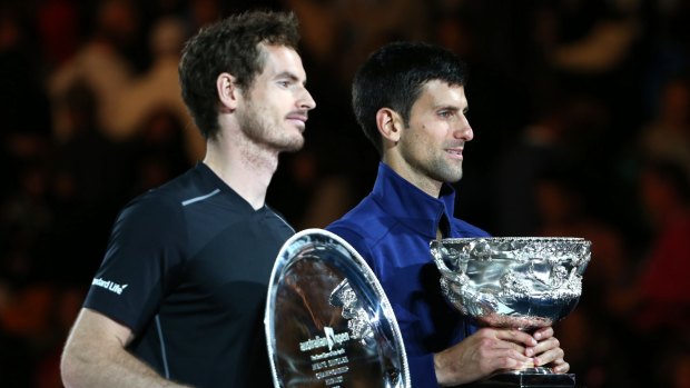 Novak Djokovic, right, of Serbia holds his trophy with runner-up Andy Murray of Britain after winning the men's singles final at the Australian Open tennis championships.