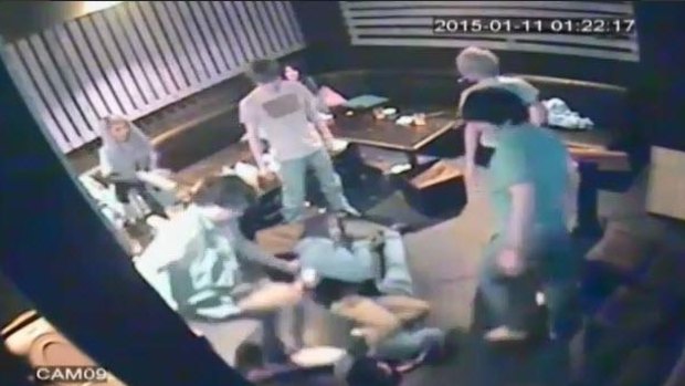 A young woman attempts to shield her boyfriend from a gang of attackers at a Melbourne karaoke bar.