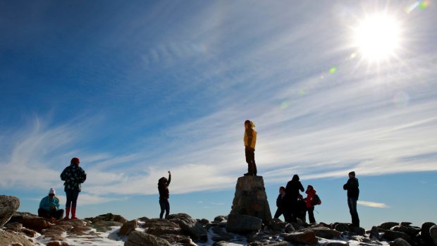 On top of Australia. Climbers at the summit of Mount Kosciuszko, 2228m above sea level.