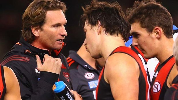 James Hird talks to his players during the match against North Melbourne Kangaroos.