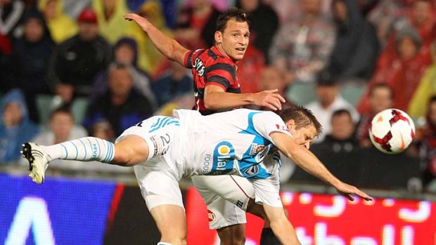 Tight match: Wanderers' Brendon Santalab and Victory's Adrian Leijer get in a tangle.