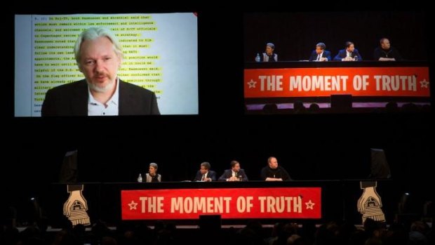 Julian Assange addresses the Auckland Town Hall meeting via video link. The meeting was also addressed by Edward Snowden.