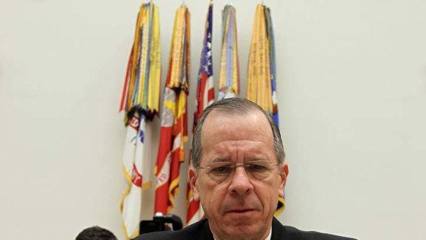 Chairman of the Joint Chiefs of Staff Admiral Michael Mullen adjusts the microphone prior to a hearing before the House Armed Services Committee on Capitol Hill.