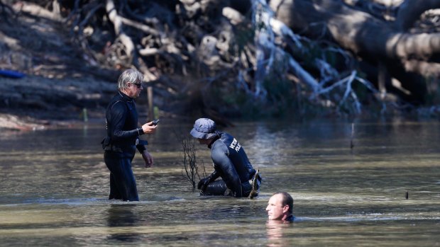 Police search the Murray for the boy.