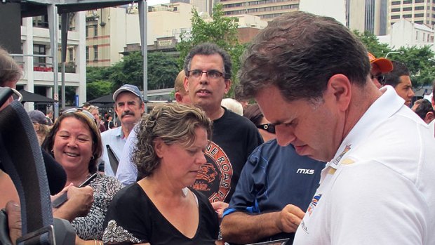 Ange Postecoglou greets fans at the Roar's victory parade today.