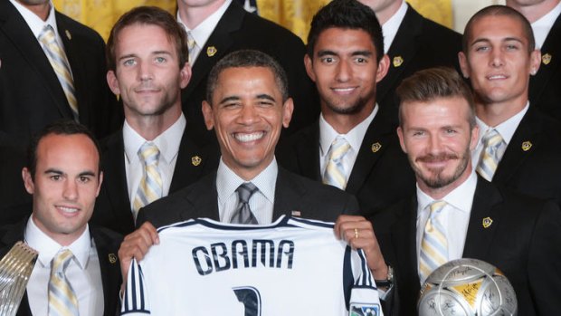 "He is tough" ... Barack Obama holds a football shirt presented to him by the LA Galaxy.