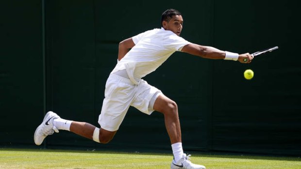 Nick Kyrgios of Australia plays a backhand during the Boys' Singles first round match against Evan Hoyt of Great Britain on day seven of the Wimbledon Lawn Tennis Championships.