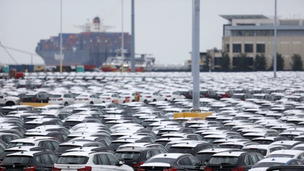 Vehicles sit parked before being driven onto vehicle carrier ships at the Port of Charleston in Charleston, South Carolina.