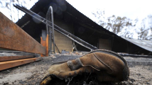 A shoe lies near a burnt-out house at Churchill.