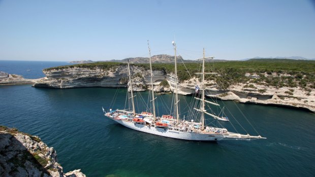 One of Star Clippers' tall ships sails into a cove in Corsica.