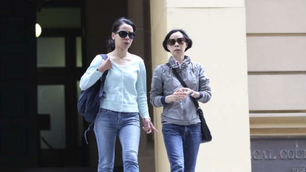 Robert Xie's wife, Kathy (left), and sister Xie Chu Ying leave Central Local Court on Wednesday.