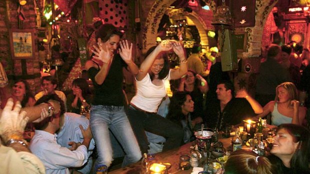 Patrons dance on their chairs at Andres Carne de Res, a popular restaurant in Chia, Bogata, Colombia.